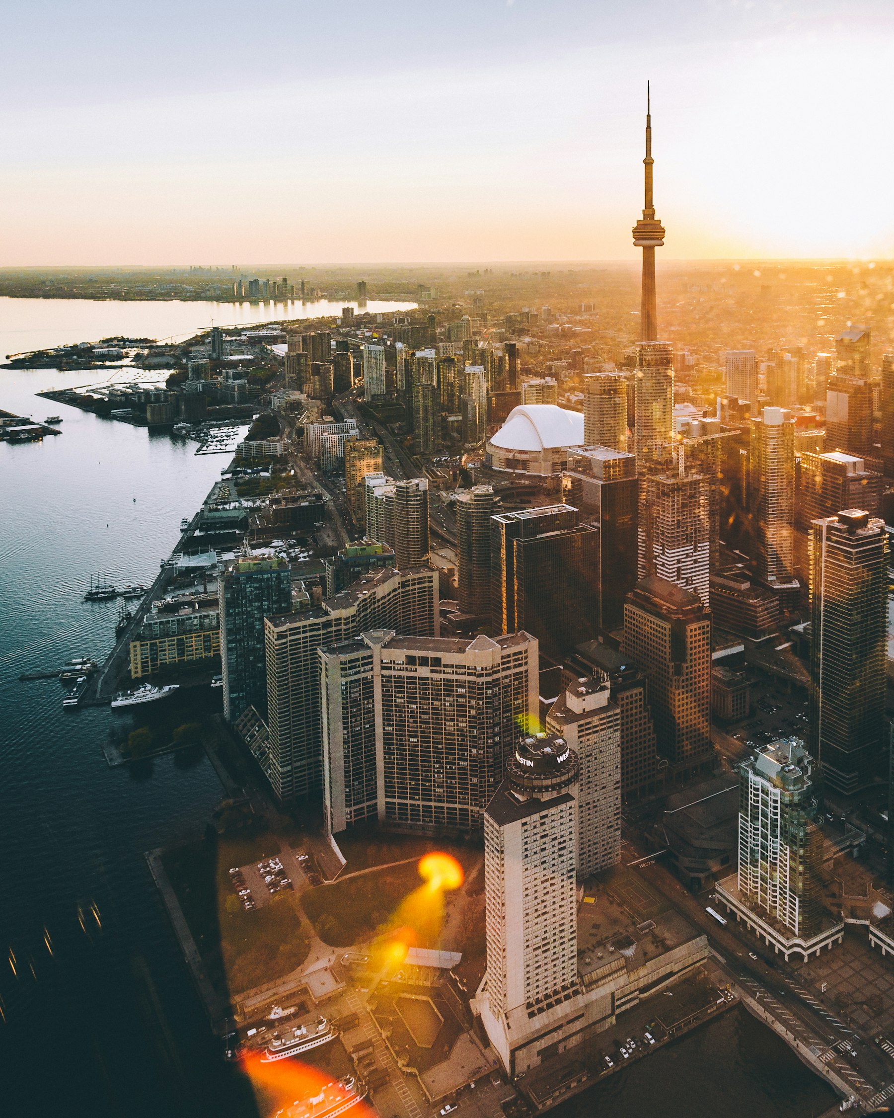 Aerial view of the Toronto waterfront and CN Tower at sunset